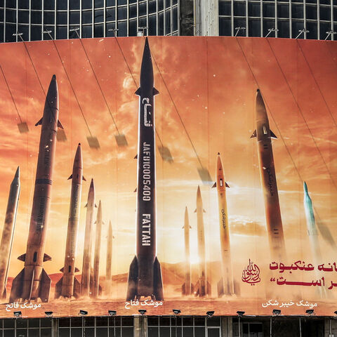 This picture taken on April 15, 2024 shows a view of a billboard depicting named Iranian ballistic missiles in service, with text in Arabic reading "the honest [person's] promise" and in Persian "Israel is weaker than a spider's web", in Valiasr Square in central Tehran. Iran on April 14 urged Israel not to retaliate militarily to an unprecedented attack overnight, which Tehran presented as a justified response to a deadly strike on its consulate building in Damascus. (Photo by ATTA KENARE / AFP) (Photo by 